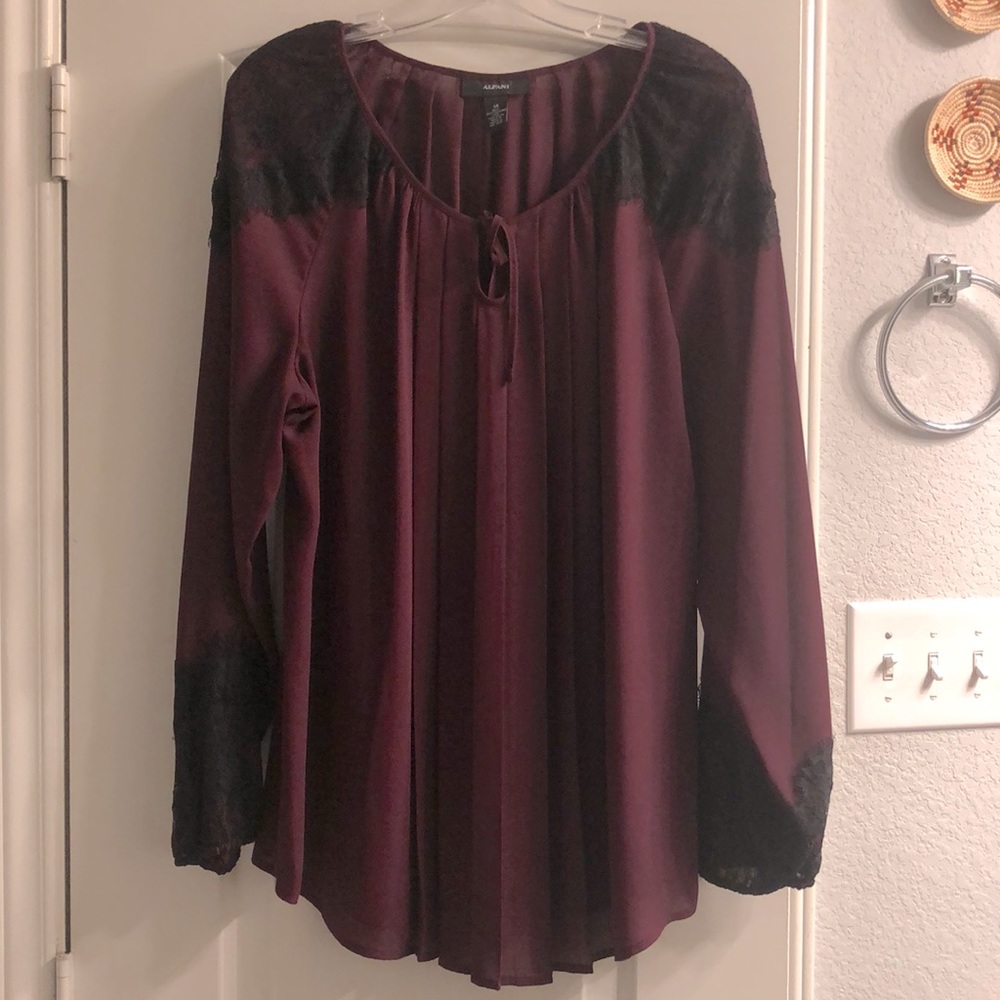 Beautiful long top with lace accents on shoulders and cuffs!